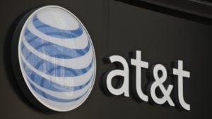 Image of AT&T (T stock) logo on a gray storefront.