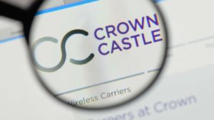 Image of Crown Castle (CCI) logo on a web browser highlighted through the lens of a magnifying glass