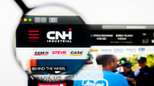 A magnifying glass is focused on the logo for CNH Industrial on the company's website.