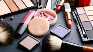 a collection of various cosmetic products on a black table