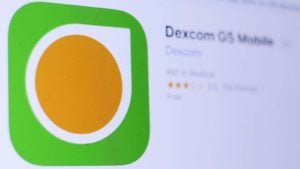 Dexcom (DXCM) logo on an app store page on a mobile phone