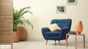 A staged room with a blue chair in focus.