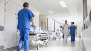 Image of a hospital with workers walking in the halls