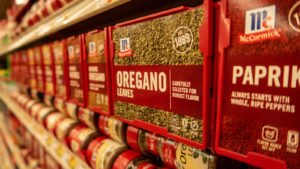 McCormick & Company spices lined up on a grocery store shelf.