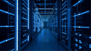 A hallway with server racks on either side in a data center