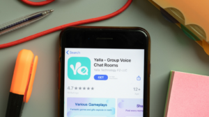 Yalla Group (YALA) Voice Chat Rooms mobile app logo on phone screen close up, Illustrative Editorial.