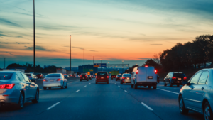 Cars on an urban highway driving into the sunset