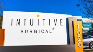 A sign with the Intuitive Surgical logo standing outside of a company office. ISRG stock.