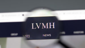 The logo for the luxury goods holding company LVMH is seen through a magnifying glass on the company's website.