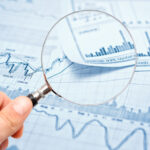 magnifying-glass-on-financal-report-stocks-getty