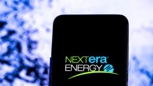 The NextEra Energy (NEE) logo is displayed on a smartphone screen.