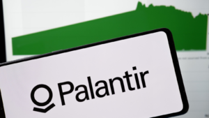 Palantir logo on the smartphone and the company share price on the day of opening the trade October 1, 2020. Palantir valued at $15.8bn in stock market debut. PLTR stock