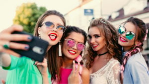 Image of teen girls taking a selfie on a shopping trip.