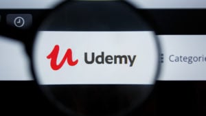 An image of the logo for Udemy through a lens.