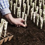 22_08_22-a-hand-planting-money-in-the-ground-to-show-long-term-investing-growth-_mf-dload