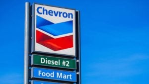 Chevron (CVX) logo on gas station sign with "diesel" and "food mart" written underneath