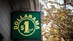 Dollarama logo in front of their local shop in downtown Montreal, Quebec.