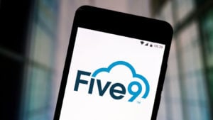 photo illustration of the Five9 logo seen displayed on a smartphone
