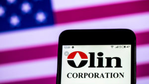 Olin Corp (OLN) logo displayed on a mobile phone screen representing dividend stocks