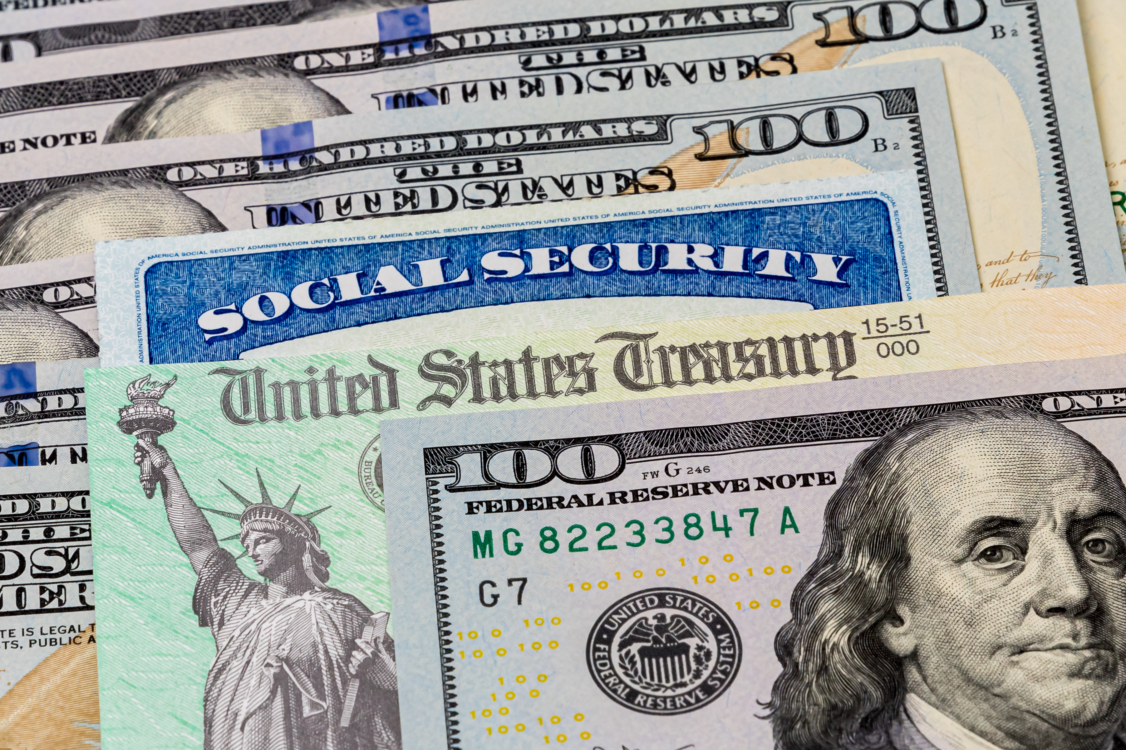 Social Security card with hundred dollar bills.