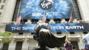 Virgin Galactic (SPCE) billboard on the New York Stock Exchange, across from the Fearless Girl statue. aerospace stocks