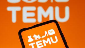 Orange Temu logo on smartphone with orange background behind it also displaying Temu logo, representing Temu, PDD Holdings and PDD stock