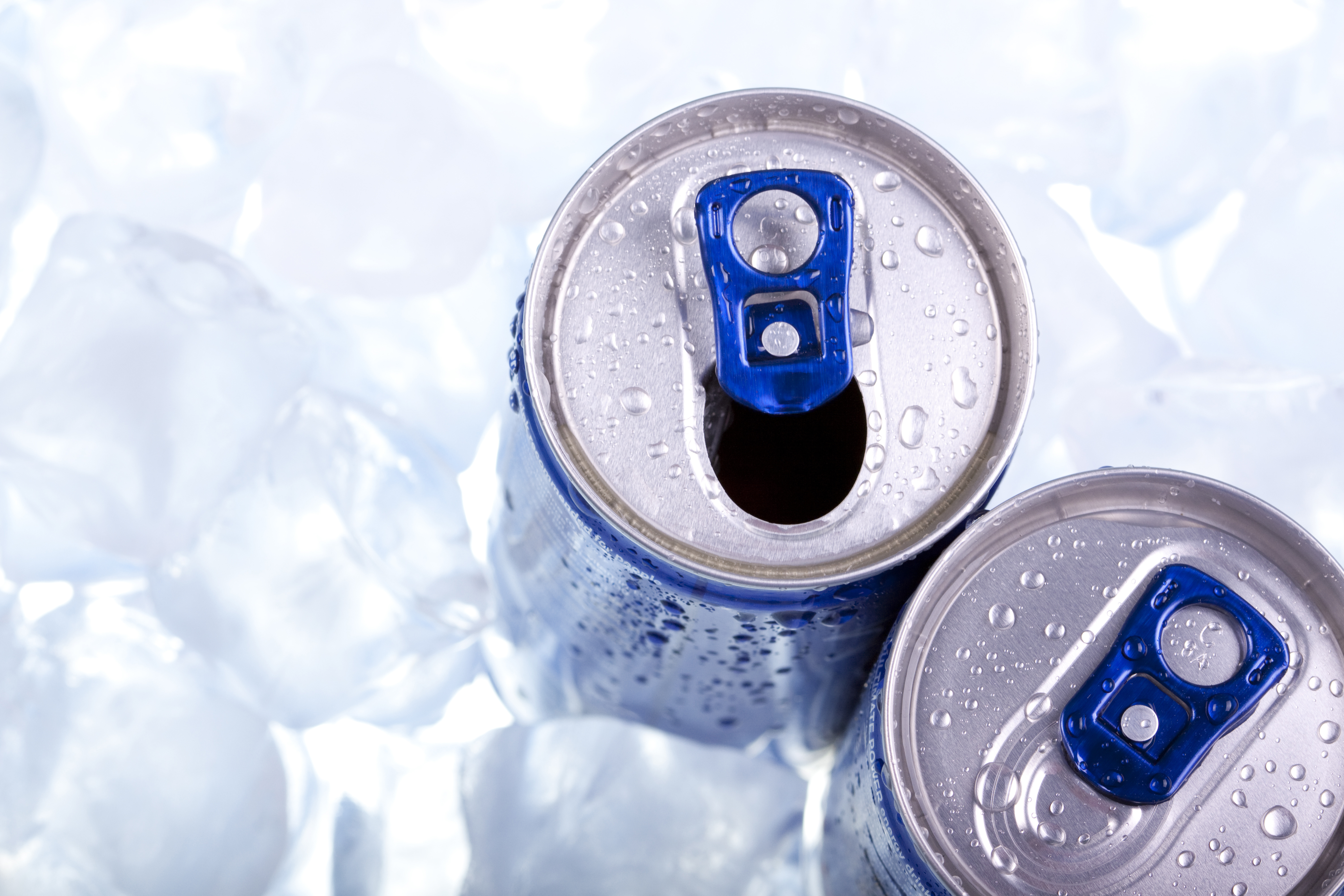 Energy drink cans on ice.