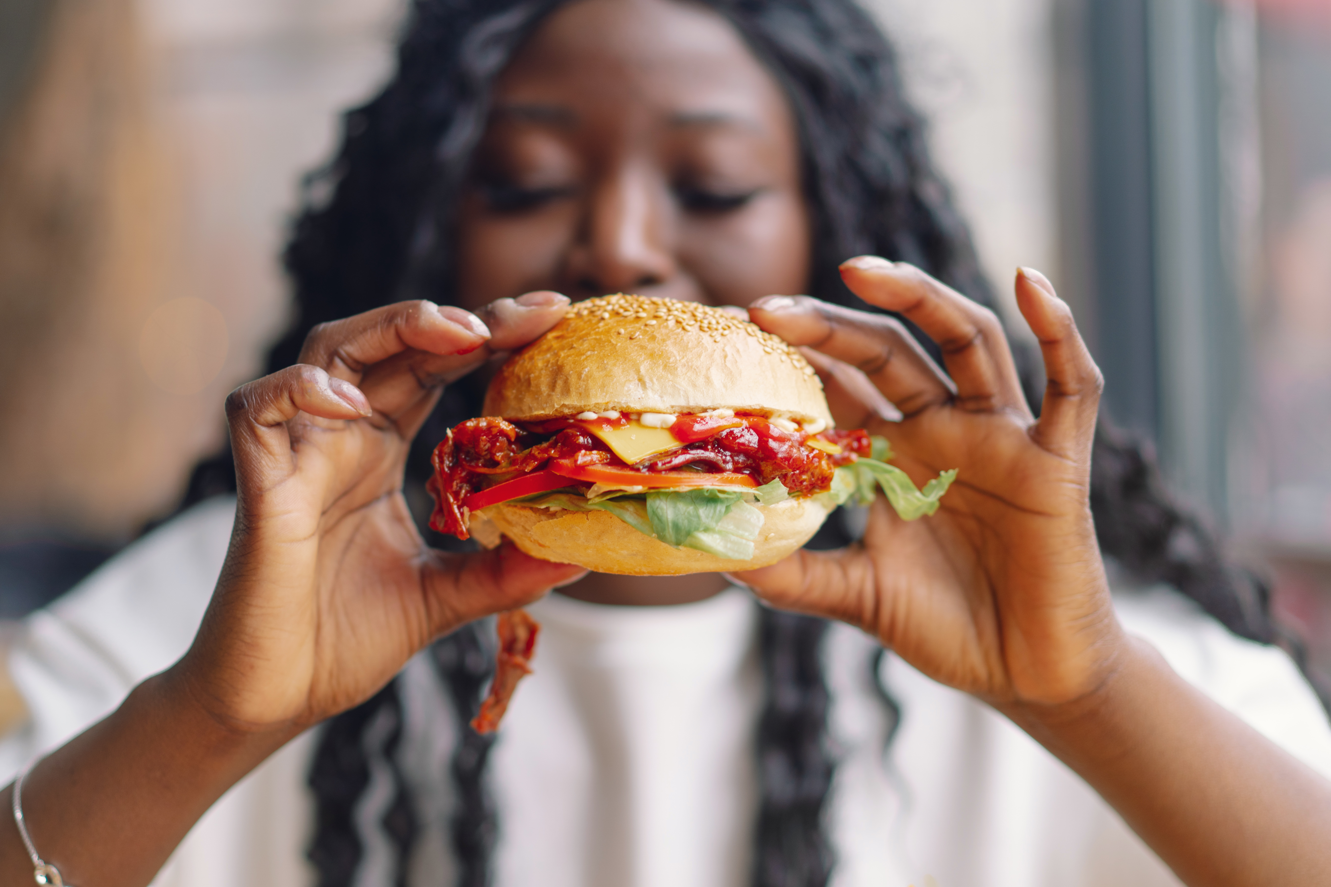 Women eating hamburger image