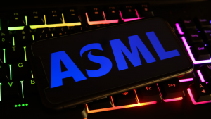 Closeup of mobile phone screen with ASML logo on computer keyboard