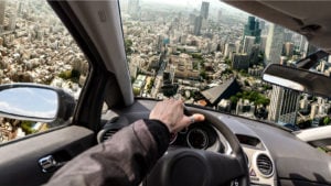 A city skyline from the point of view of a man driving a flying car; best flying car stocks