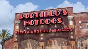 The front of a Portillo's (PTLO) hotdog restaurant in Riverside, California.