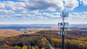 rural broadband: a cell phone tower over a long stretch of hills and forest