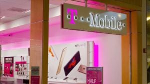 The logo for T-Mobile is displayed on a sign for an indoor retail storefront.