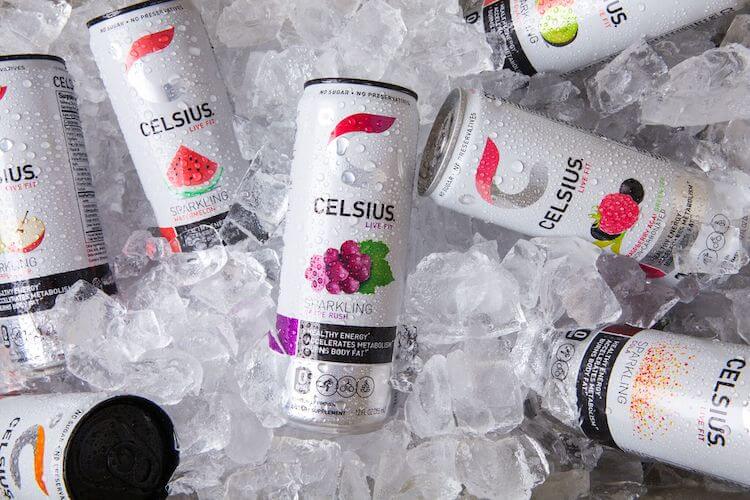 Several Celsius energy drinks sitting on ice.