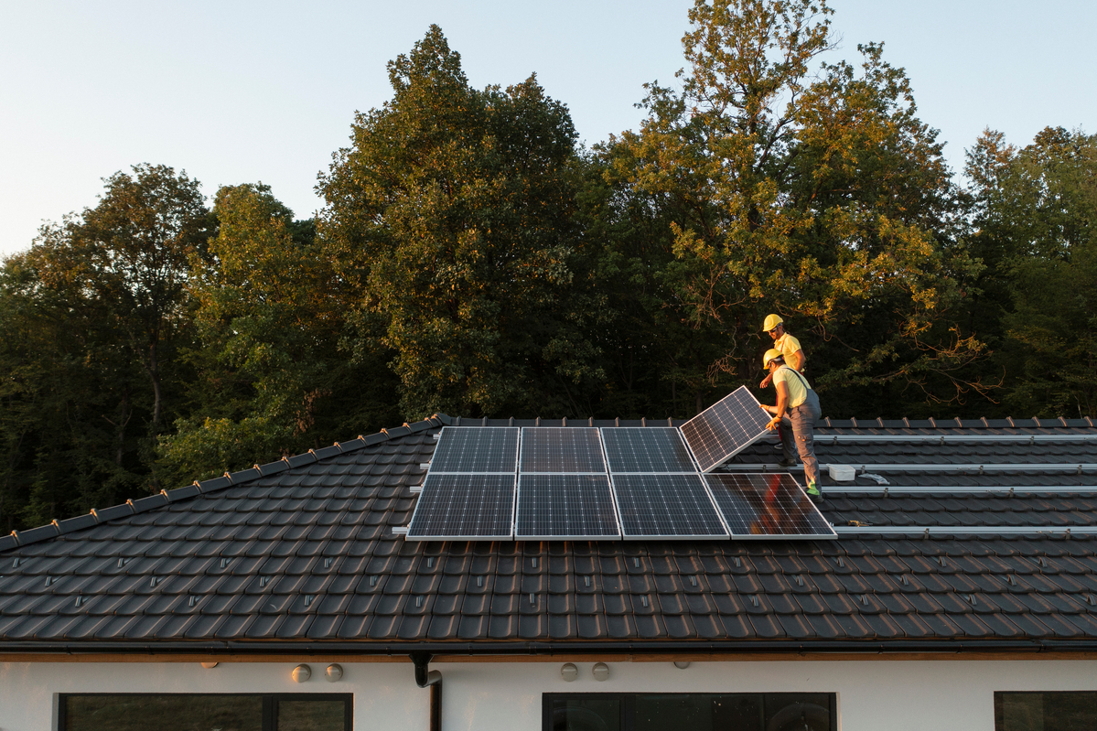 People installing rooftop solar panels. 