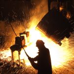22_02_07-steel-mill-with-sparks-flying-and-person-in-the-foreground-_gettyimages-177541735
