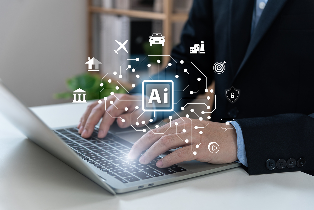 Someone typing on a keyboard with the letters AI above it.