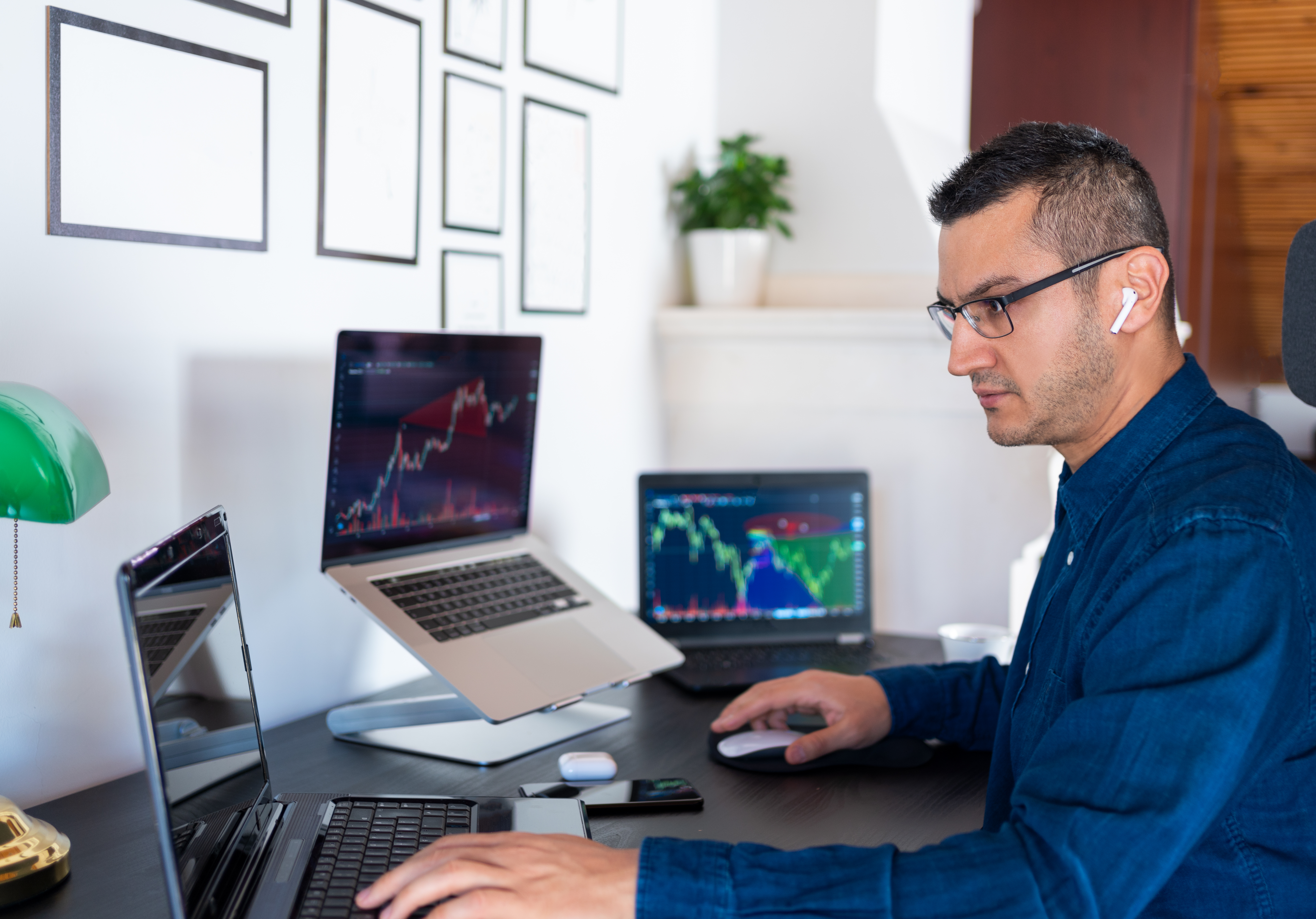 Serious investor looking at many monitors.