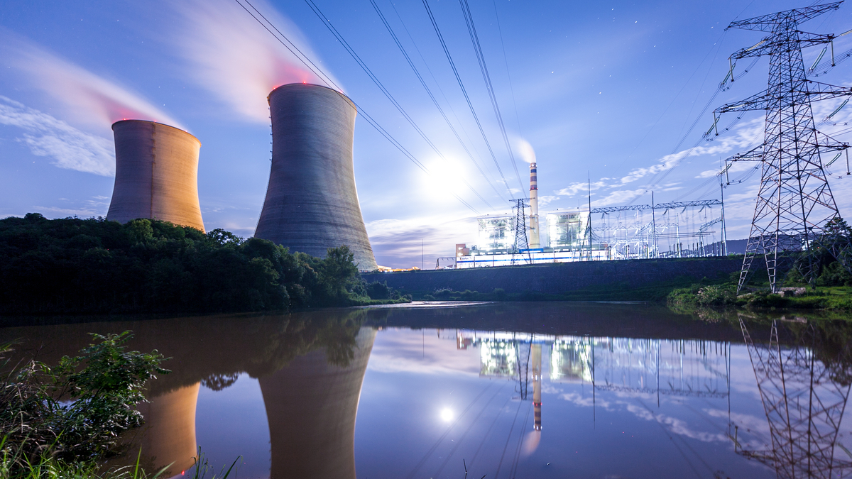 Nuclear reactors with power lines overhead.
