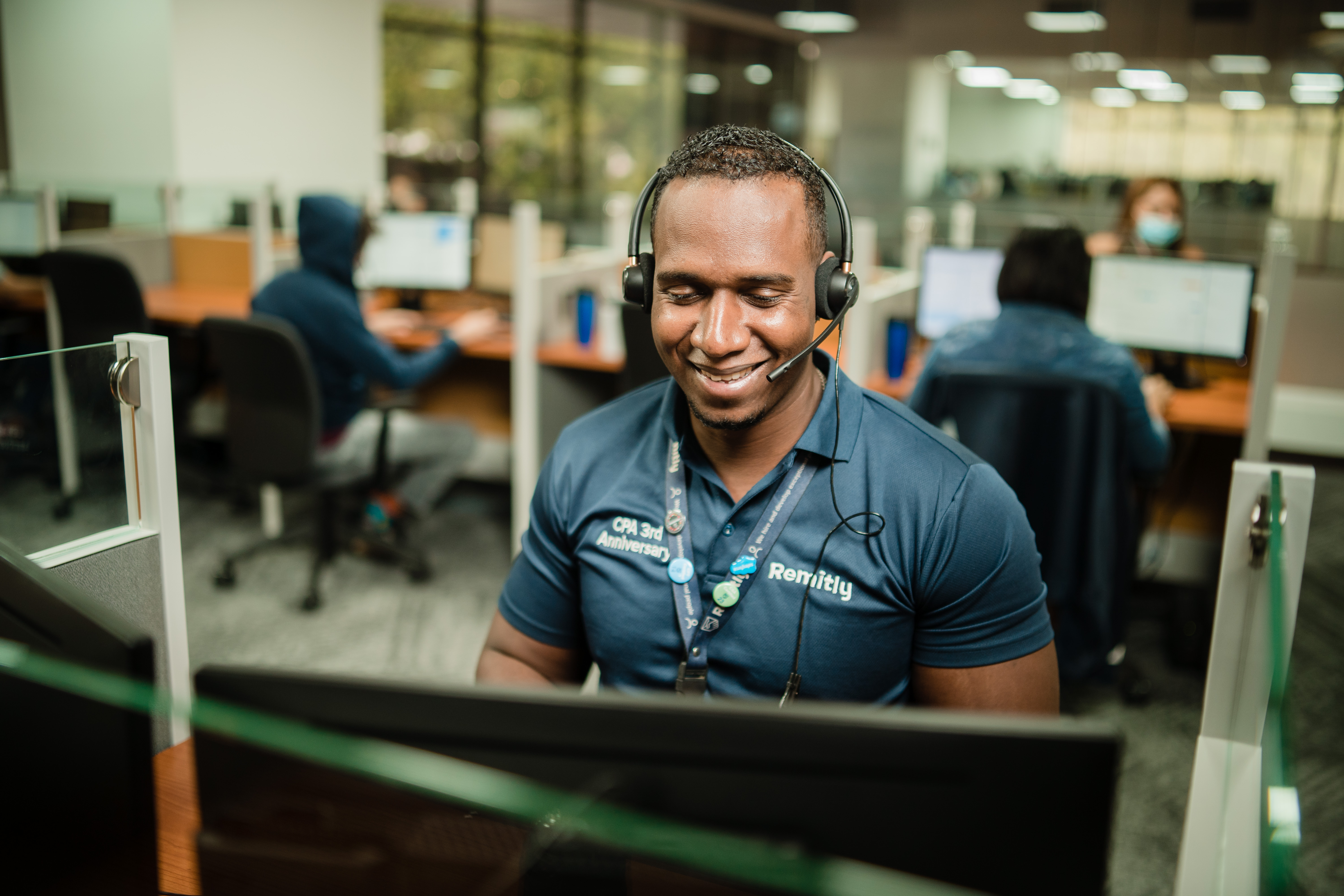 A Remitly customer service agent in an office.